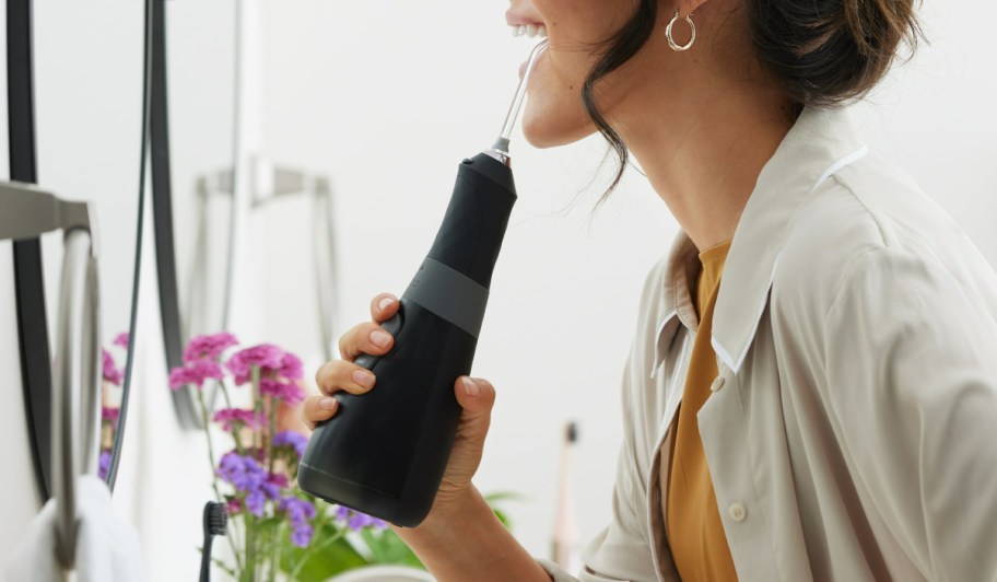 woman using a burst flosser