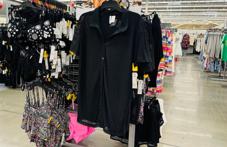 black mesh beach cover up hanging on store shelf