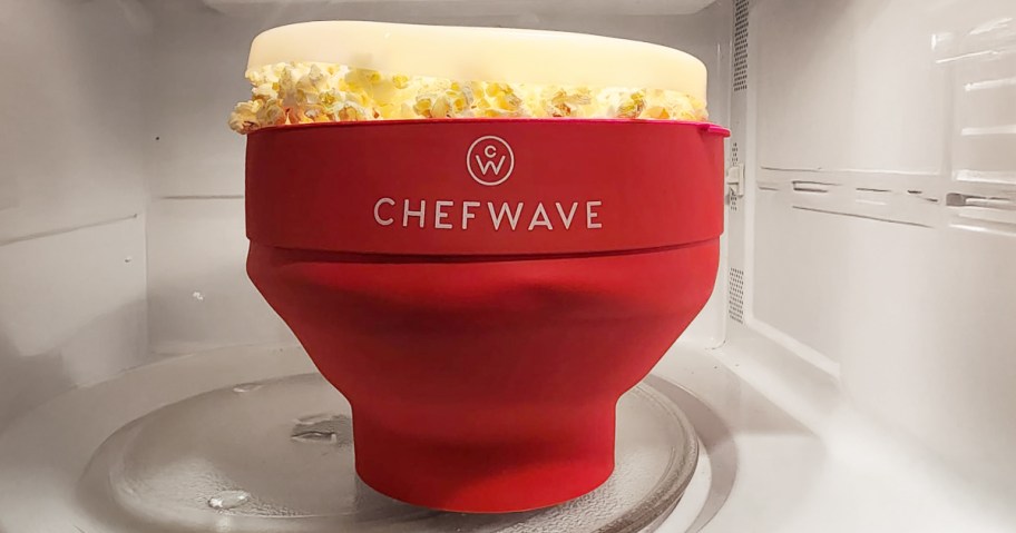 red microwave popcorn popper filled with popcorn