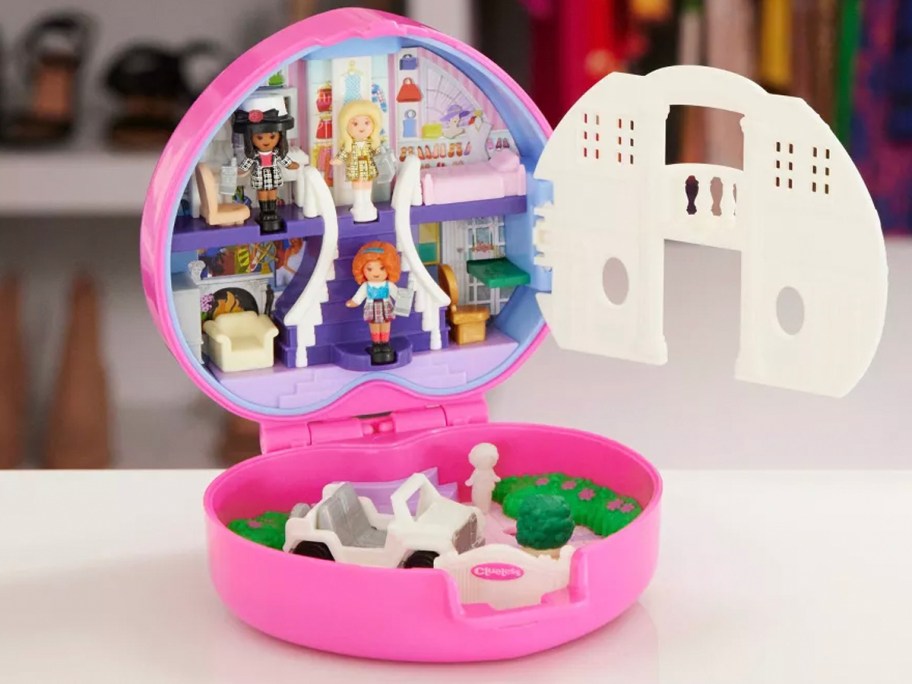 polly pocket clueless playset with figures inside on table 