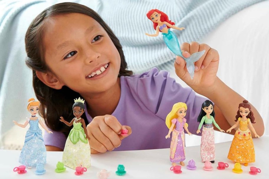 girl playing with princess dolls