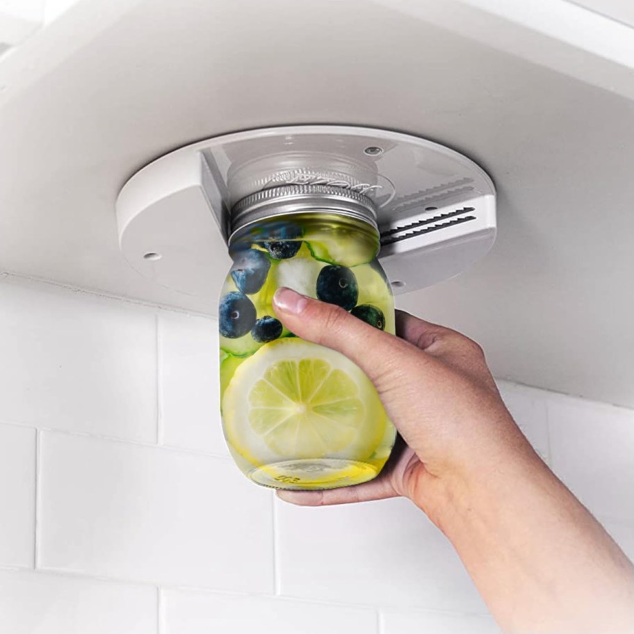 hand using the ez jar opener, one of the cool kitchen gadgets of 2024 that makes a great gift for seniors and those with arthritis