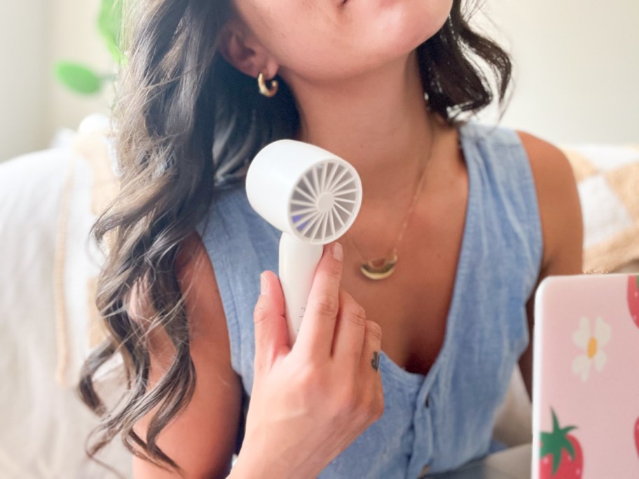 woman using personal fan