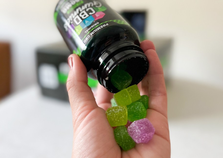 hand dumping CBD gummies into palm