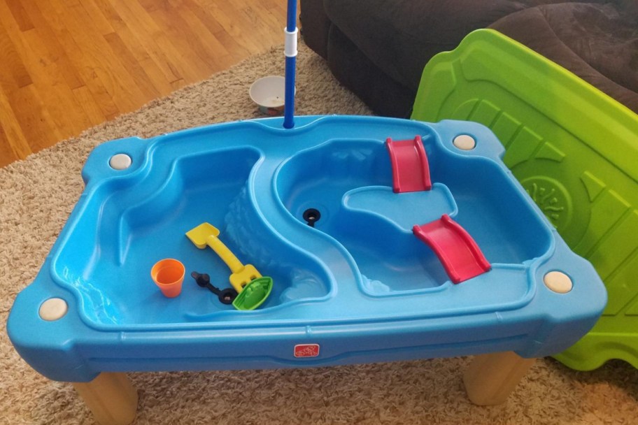 empty two sided water table with green lid