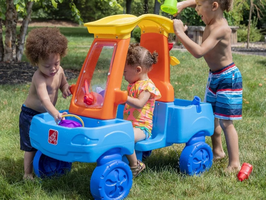 three kids in car themed water table