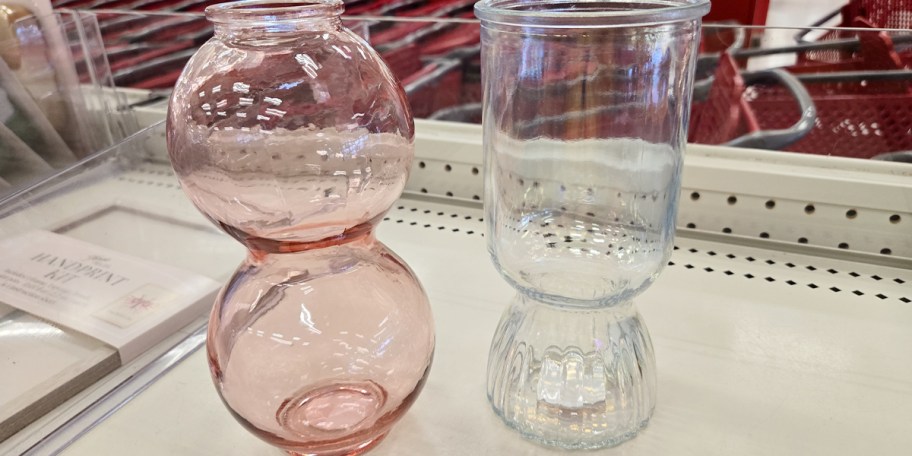 pink and clear glass vases on shelf 