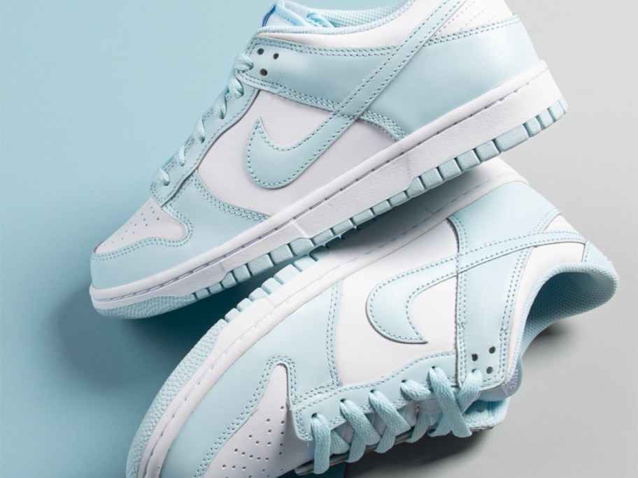 a pair of white and light blue nike dunk shoes