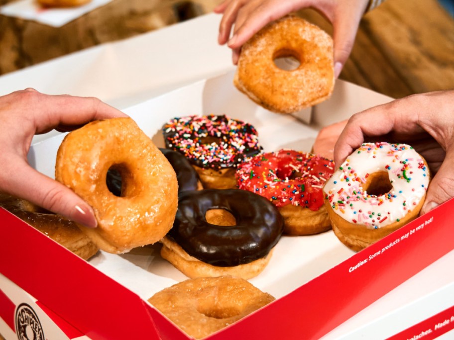taking doughnuts from a red box