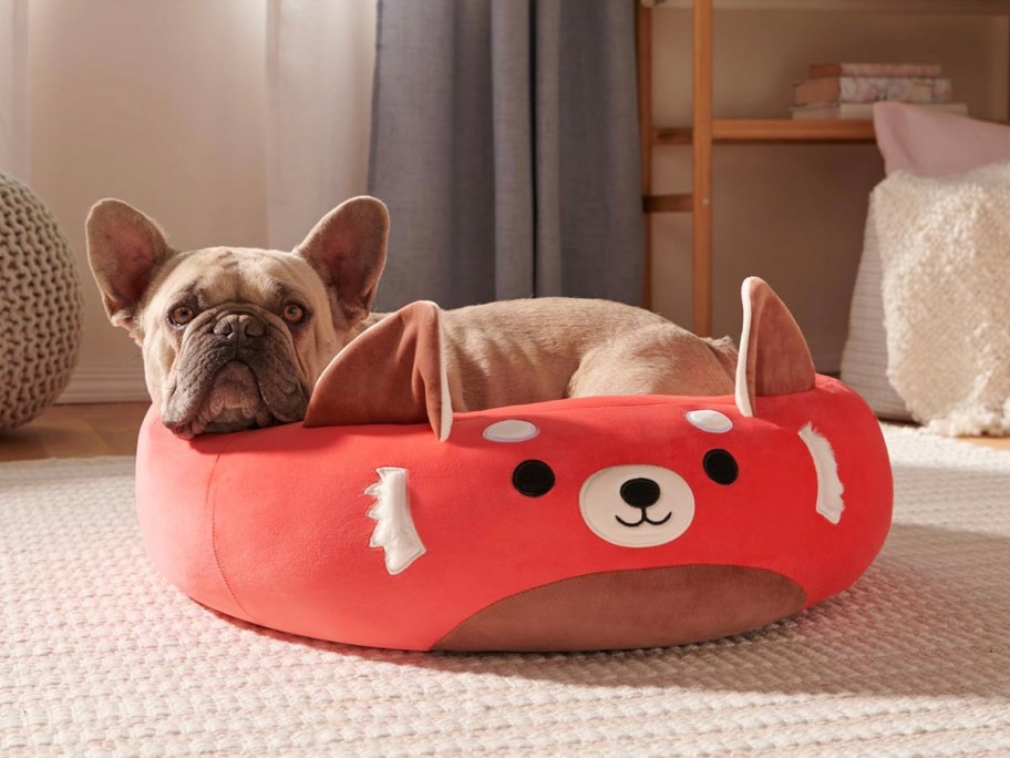 dog laying in red panda dog bed