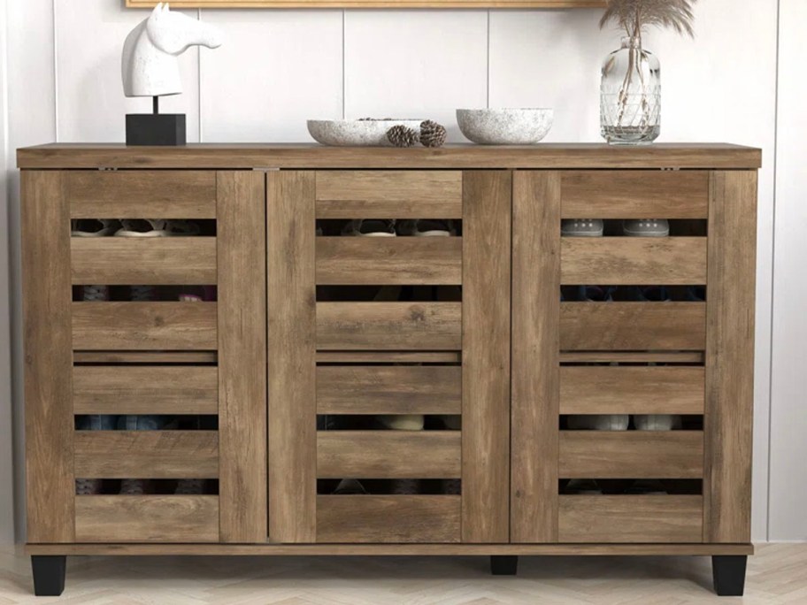 brown shoe storage cabinet near front door 
