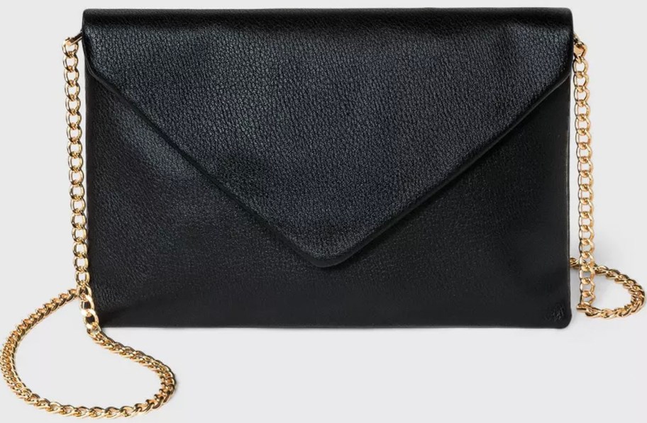 black envelope clutch bag with gold chain stock image