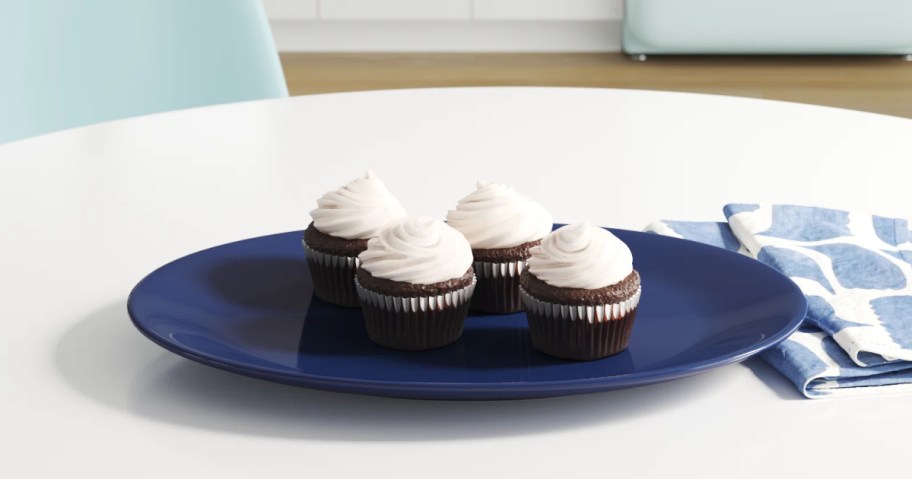 blue serving platter displayed with frosted cupcakes