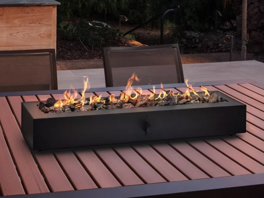 a large black tabletop firepit on a patio table