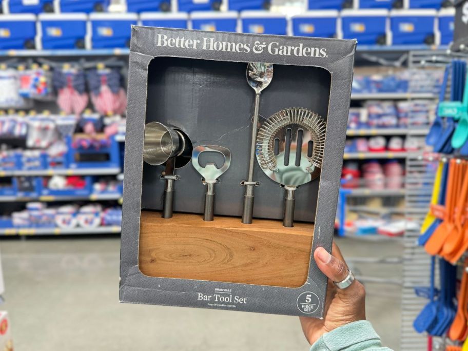 a womans hand holding a 5 piece bar set 