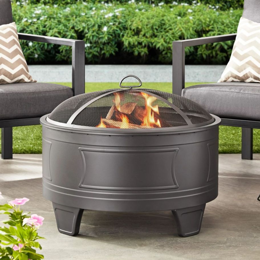  a silver fire pit on a patio