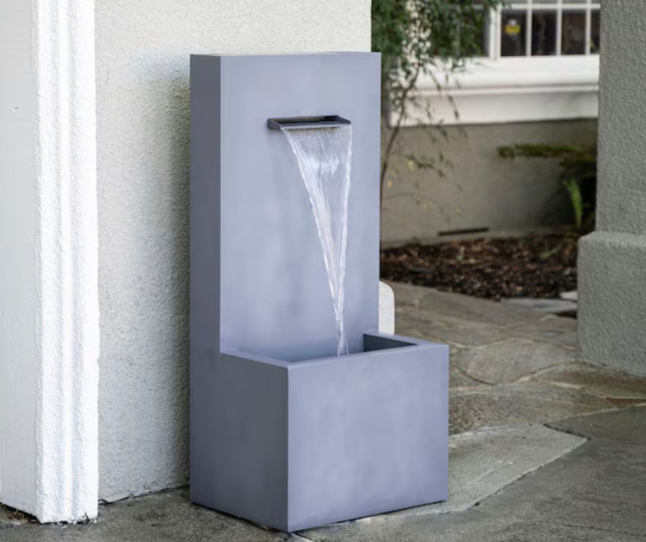 gray concrete water fountain on patio