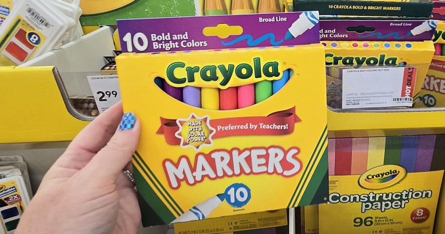 hand holding up a box of Crayola Broad Line Bold and Bright Markers in store
