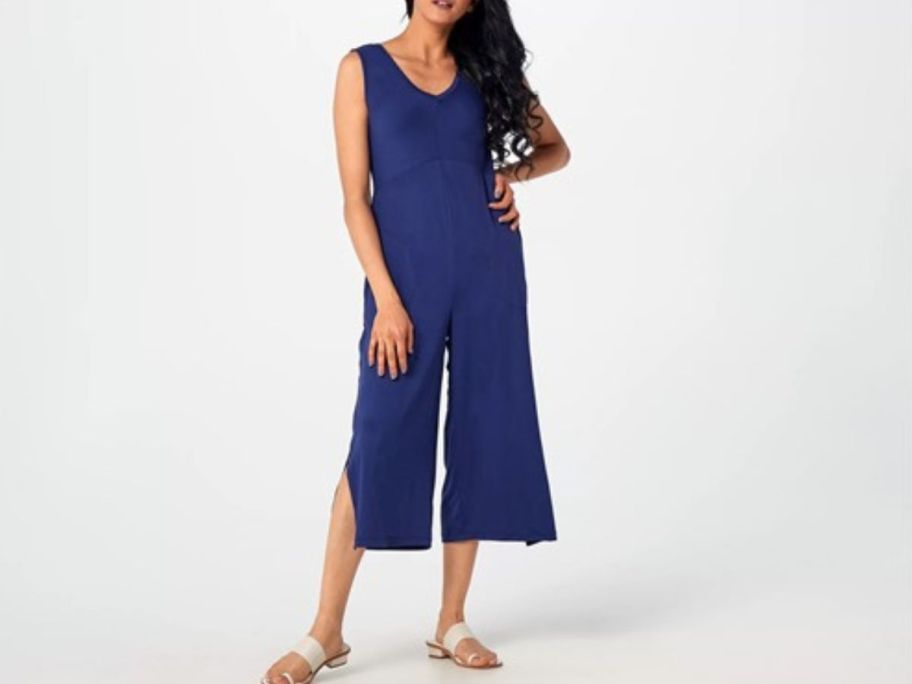 A woman wearing a Cuddl Duds Flexwear V-Neck Jumpsuit in blue