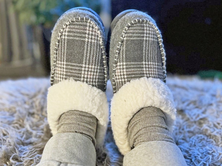 person wearing grey plaid slippers