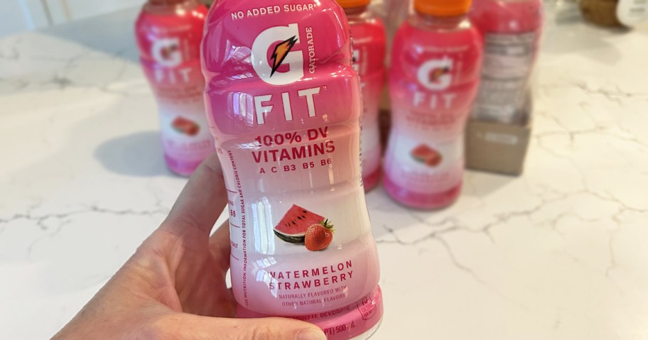 hand holding up a pink bottle of Gatorade Fit