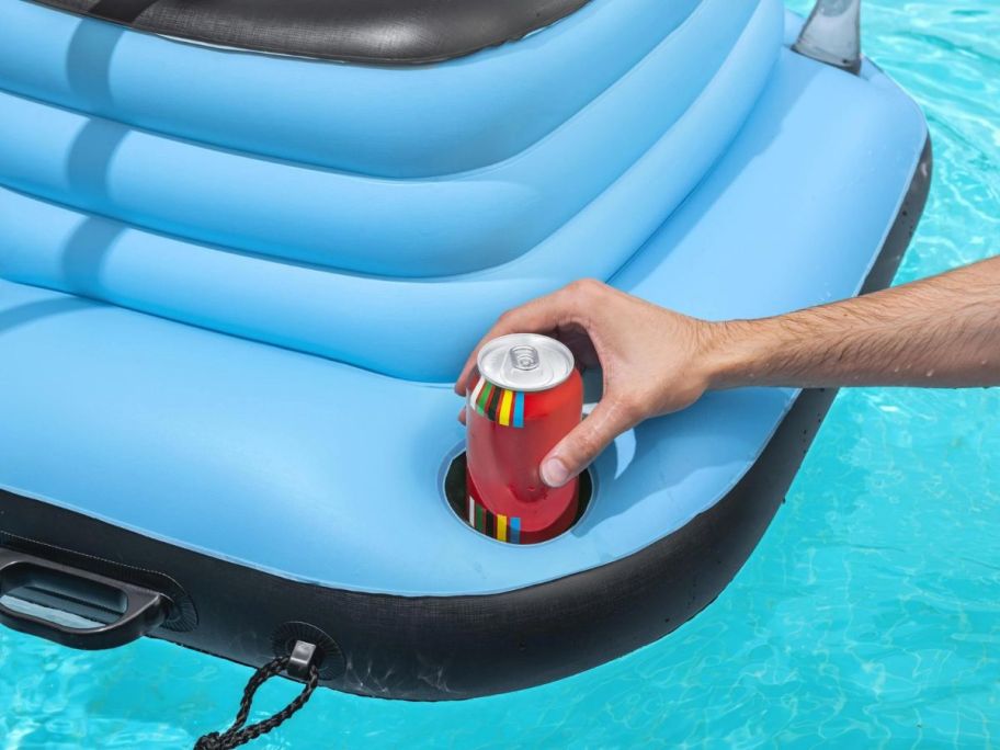 hand putting drink on H2OGO! Inflatable 9-Gallon Floating Cooler