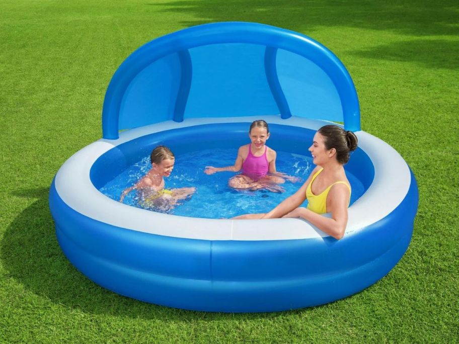 3 people in an inflatable pool
