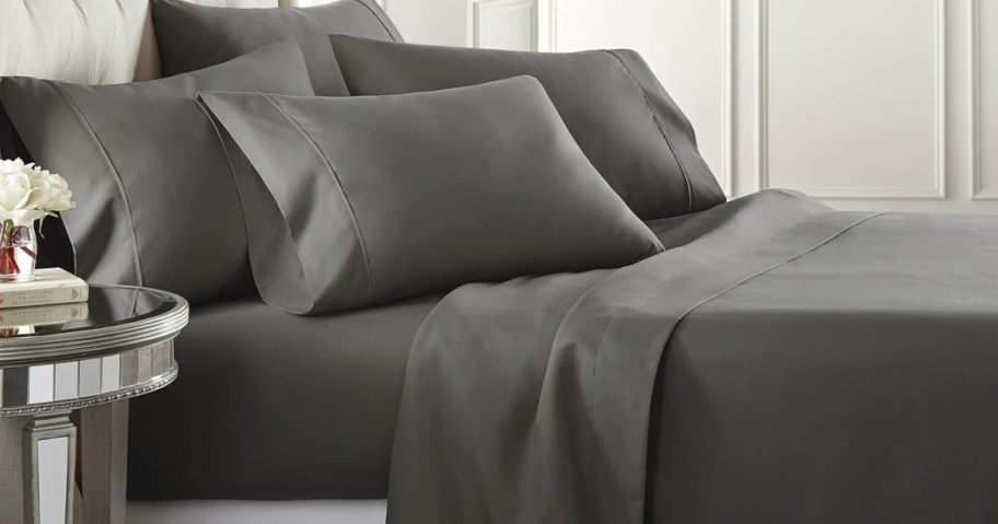 bed with dark grey sheets and pillows in dark grey pillowcases