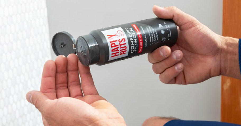 man pouring a bottle of Happy Nuts Comfort Powder
