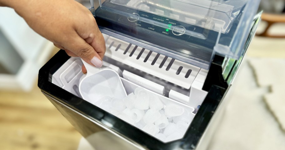 hand using scoop in countertop ice maker