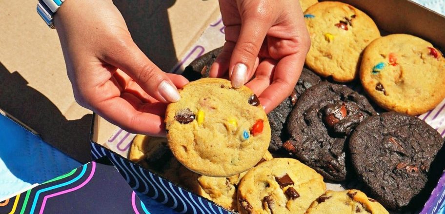 hands holding an m&ms cookie