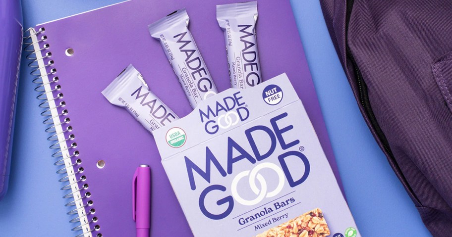 box of MadeGood Mixed Berry Granola Bars on top of a purple spiral notebook