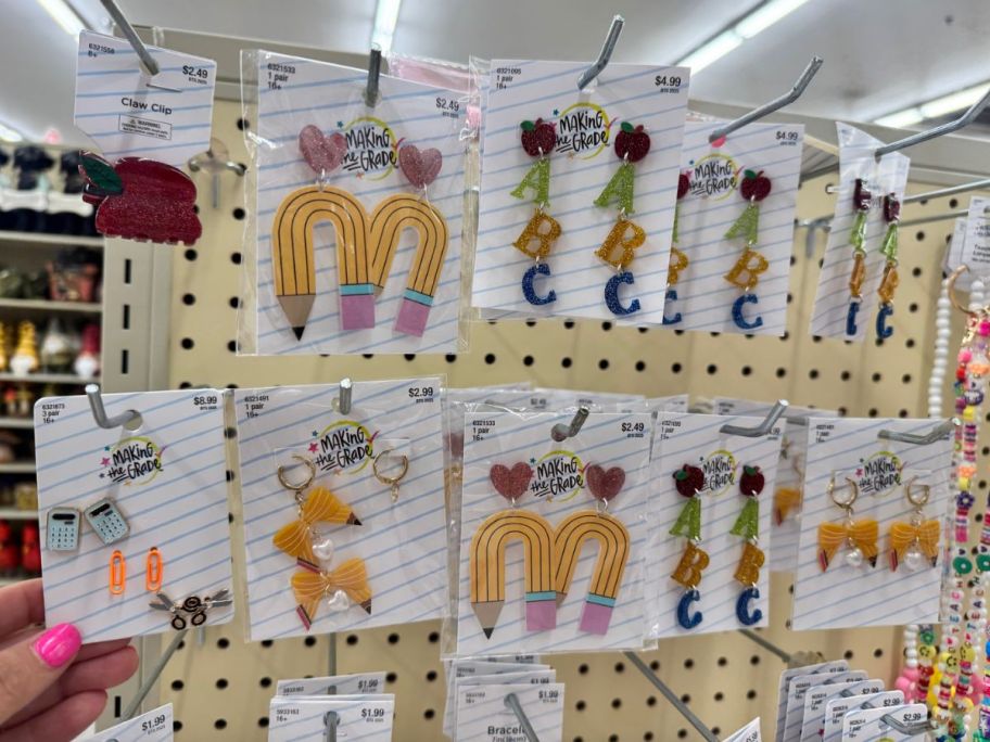 Hand holding one type of teacher earring 