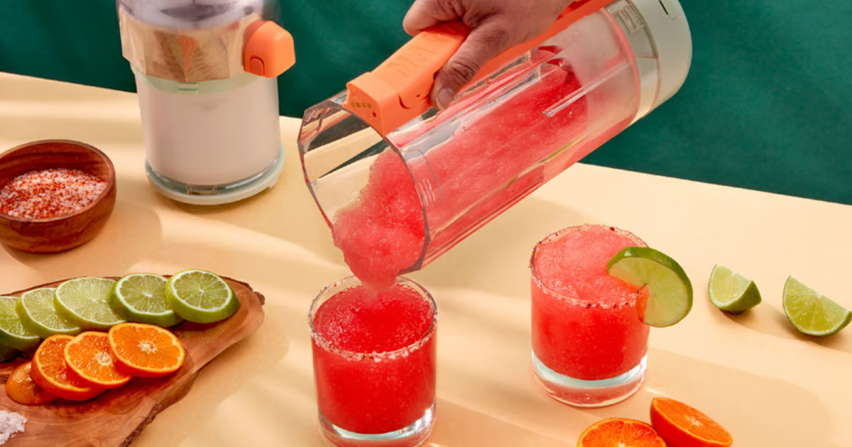 person pouring red frozen drink into cups