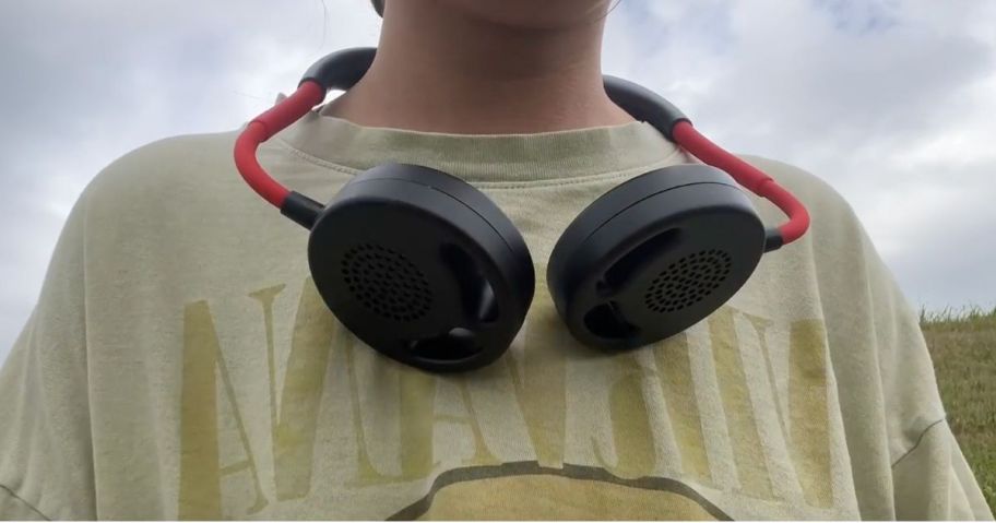 Person wearing a portable neck fan