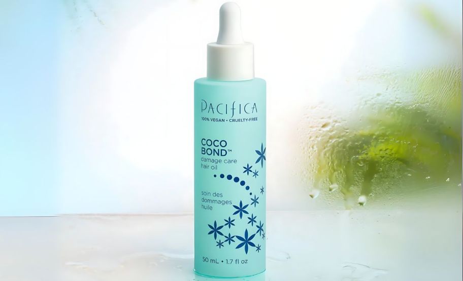 A bottle of pacifica coco bond on a frosted blue background