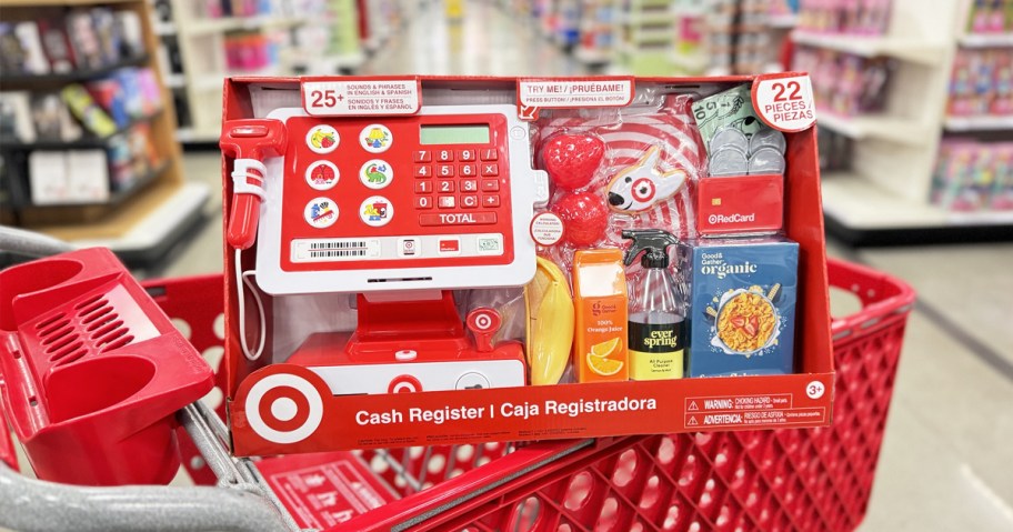 Target Toy Cash Register sitting on top of red shopping cart