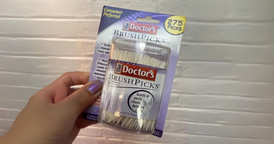 hand holding The Doctor's Brushpicks Interdental Toothpicks 275-Count pack