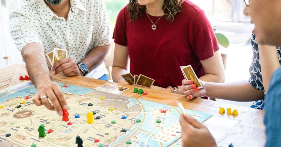 people playing Underdog Games Trekking The National Parks Family Board Game