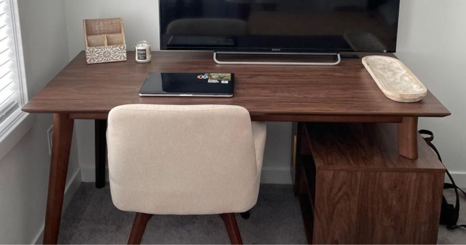 Union & Scale™ MidMod 60"W Computer and Writing Storage Desk with chair in front of it and screen, laptop, and office supplies on it