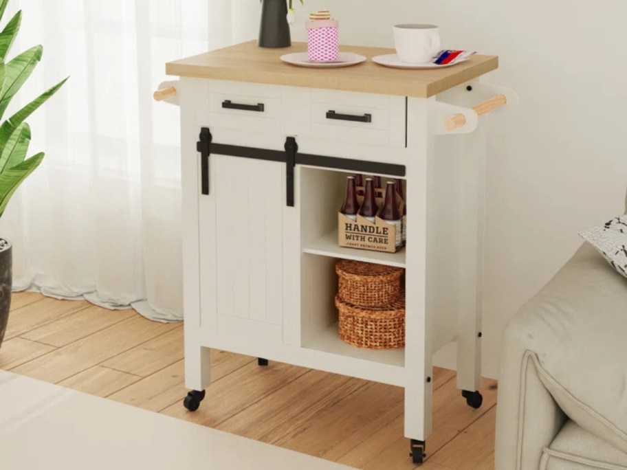 Gracie Oaks Newmann Wood Kitchen Cart against wall