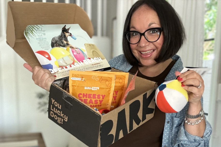 lina holding barkbox with beach ball toy