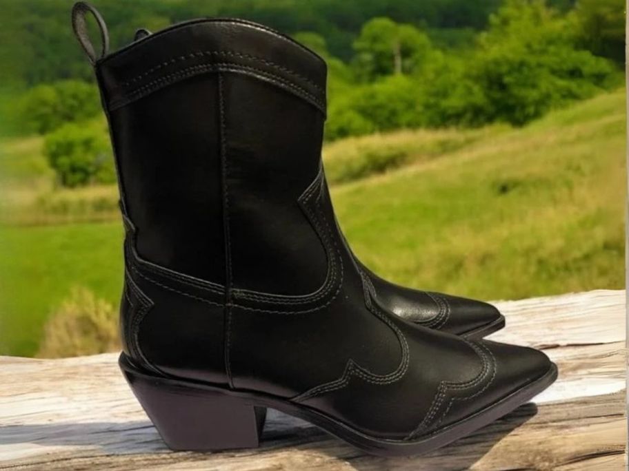 black Madden Girl Women's Swifty Western Ankle Boots on fence