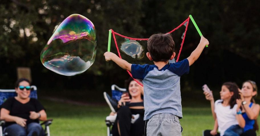 boy making bubbles with the WOWmazing Grab-N-Go Complete bubble Kit