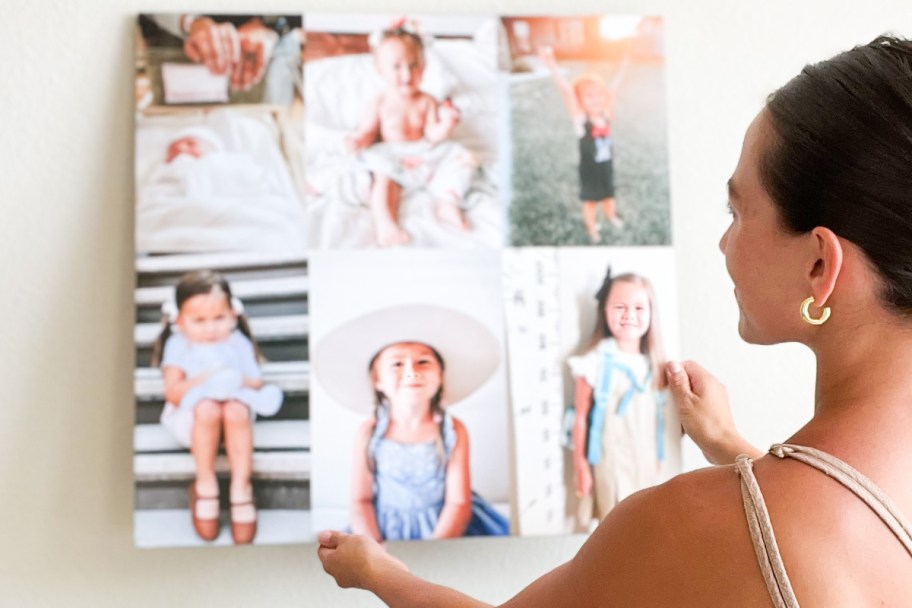 woman holding canvas on wall