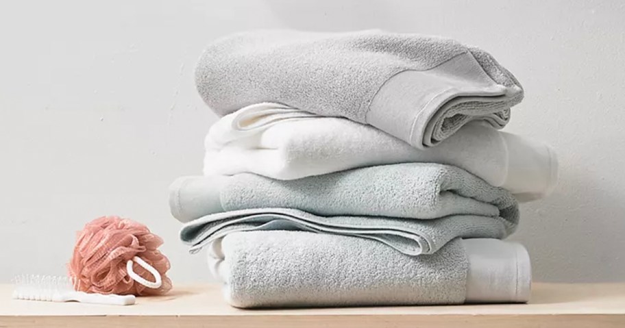 white and gray towels stacked on countertop