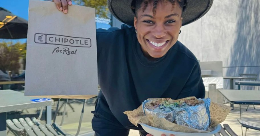 woman holding chipolte bag and burrito