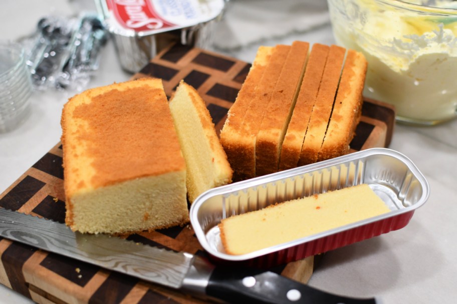 cutting up a sara lee pound cake on a cutting board