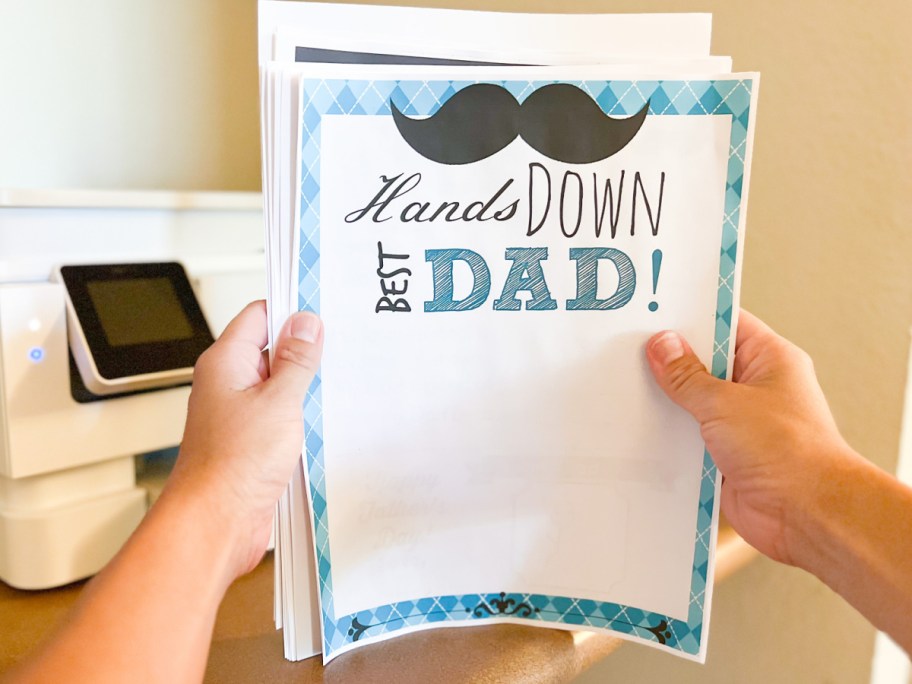 hands holding fathers day paper