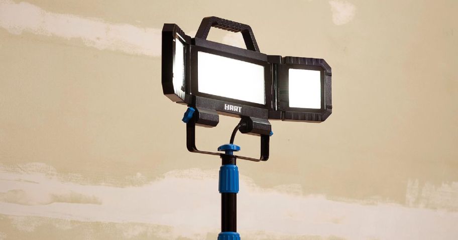 HART Multi-Directional LED 3-Head 7000 Lumen Work Light with Tripod, Adjustable, 7000 Lumens standing in garage